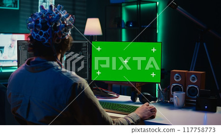 IT admin coding and using EEG headset to upload brain into mockup computer, gaining immortality. Neuroscientist engineering transhumanism experiment on isolated screen PC, camera B 117758773