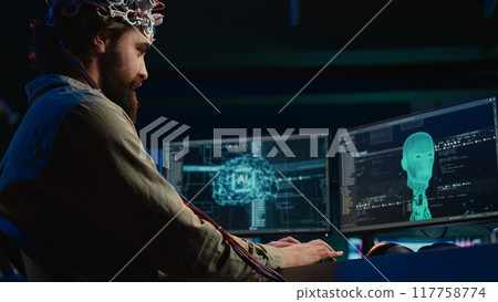 IT admin coding and using EEG headset to upload brain into computer, gaining immortality. Neuroscientist engineering transhumanism experiment, inserting consciousness into cyberspace, camera B IT admin coding and using EEG headset to upload brain into computer, gaining immortality. Neuroscientist engineering transhumanism experiment, inserting consciousness into cyberspace, camera B 117758774