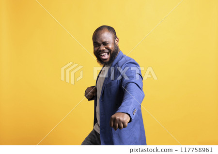 Portrait of showy african american motivational speaker gesturing with hands with determination, isolated over studio background. Expressive vigorous BIPOC lecturer inspiring motivation 117758961