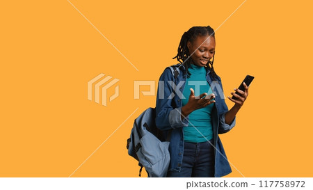 Upset african american woman arguing with friends during teleconference meeting on smartphone, studio background. Annoyed girl fighting on mobile phone videocall with mates, camera B Upset african american woman arguing with friends during teleconference meeting on smartphone, studio background. Annoyed girl fighting on mobile phone videocall with mates, camera B 117758972