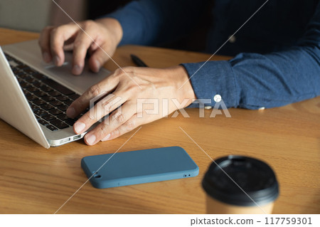 Man working on laptop 117759301