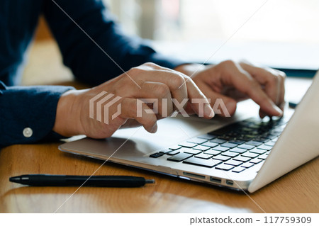 Man working on laptop 117759309