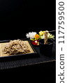 Japanese soba noodles served in a colander and dipped in noodle sauce 117759500