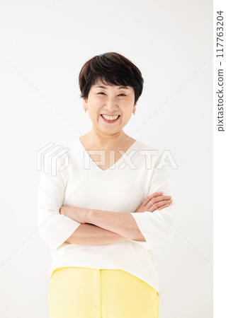 Senior woman with arms crossed Senior woman with arms crossed 117763204