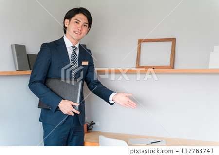 Salesman showing around the model house workspace Salesman showing around the model house workspace 117763741