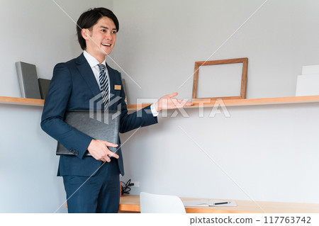 Salesman showing around the model house workspace Salesman showing around the model house workspace 117763742