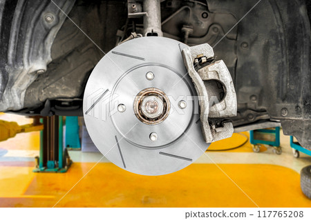 Install new slotted brake rotors on the car in the auto repair center 117765208