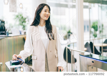A woman passing through a security gate 117766092