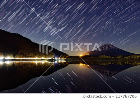 Night view of Mt. Fuji and the rising winter constellations from the shores of Lake Shojiko 117767706