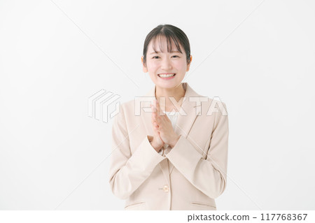 A woman in her twenties wearing a beige jacket 117768367