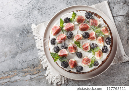 Dark mood cake with Figs, Blackberry and Ricotta Cake closeup on the plate. Horizontal top view Dark mood cake with Figs, Blackberry and Ricotta Cake closeup on the plate. Horizontal top view 117768511