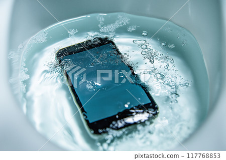 A smartphone dropped into a toilet bowl. Image of water damage 117768853