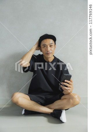 Man in cap sitting 117769146