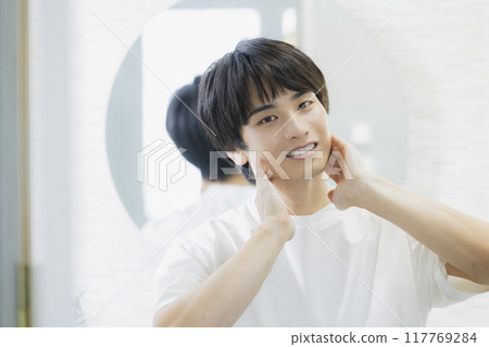 Man doing skin care in the bathroom 117769284