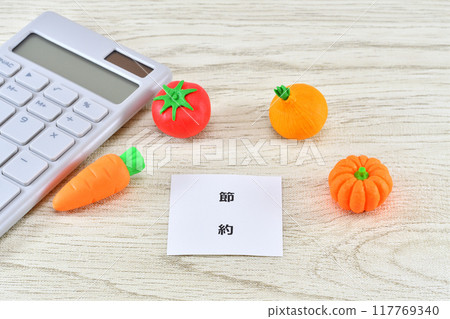 Image of saving money on food with vegetables, a calculator and saving money 117769340