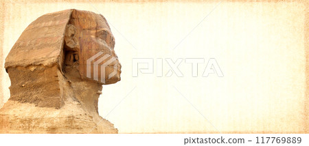 Grunge background with paper texture and face of famous Great Sphinx. Horizontal banner with ancient egyptian sphinx in Giza Necropolis, Cairo, Egypt. Copy space for text. Mock up template 117769889
