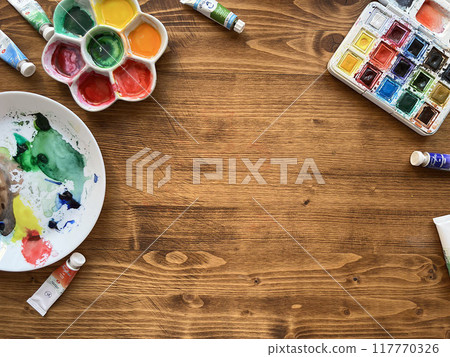 Top view above creative desk. Watercolor paints on wooden table. Top view above creative desk. Watercolor paints on wooden table. 117770326