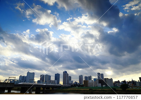 The Tokaido Shinkansen crosses a railway bridge over the Tama River under a dramatic cloudy sky The Tokaido Shinkansen crosses a railway bridge over the Tama River under a dramatic cloudy sky 117770857