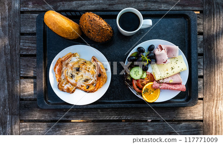 Classic breakfast with bread buns, ham, cheese, fruits and sweet pastry, Dahme, Germany Classic breakfast with bread buns, ham, cheese, fruits and sweet pastry, Dahme, Germany 117771009
