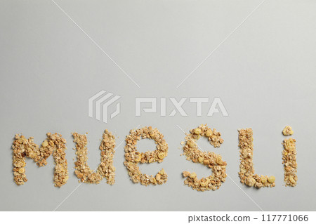 The word muesli from muesli granules on a gray background 117771066