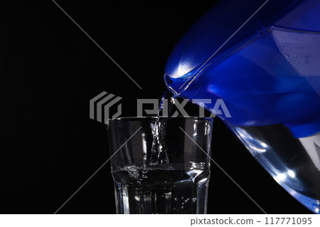 Modern water filter on a black background 117771095