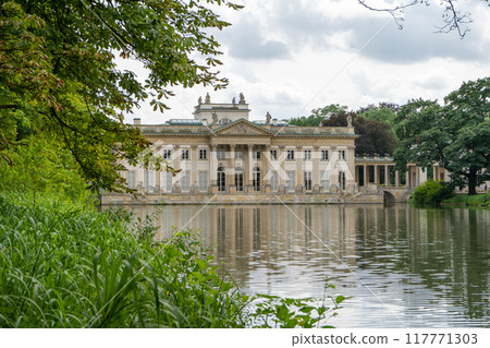 Lazienki Park with pond. Polish Lazienkowski or Lazienki Krolewskie is the polish park. The palace on the water is a monument of architecture. Lazienki Park with pond. Polish Lazienkowski or Lazienki Krolewskie is the polish park. The palace on the water is a monument of architecture. 117771303