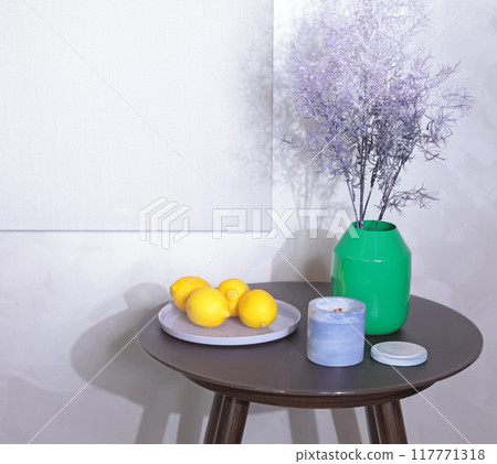 Coffee table with items in lavender and green color palette. Yellow lemons in glass plate. Linen canvas for painting. Mockup for design. Coffee table with items in lavender and green color palette. Yellow lemons in glass plate. Linen canvas for painting. Mockup for design. 117771318