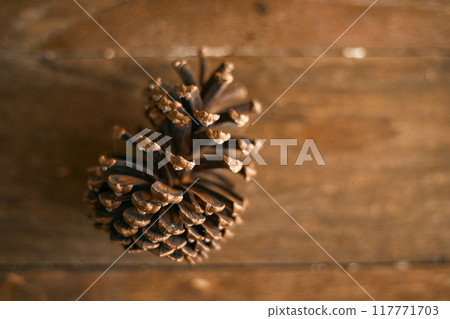 Close up pine cones on beige background Close up pine cones on beige background 117771703