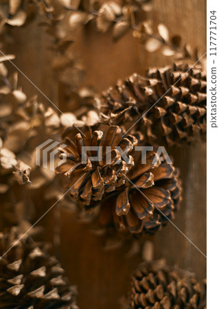 Close up pine cones on beige background Close up pine cones on beige background 117771704