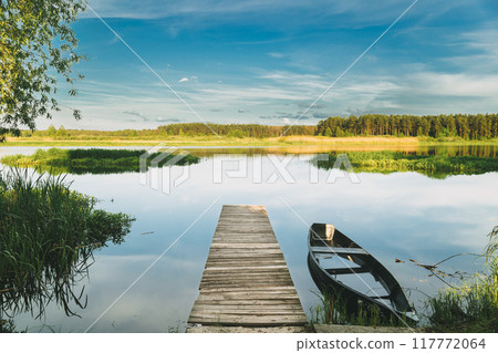 Old Wooden Fishing Boat Near Pier In Summer Lake Or River. Beautiful Summer Sunny Day Or Evening. Forsaken Boat. Russian Nature 117772064