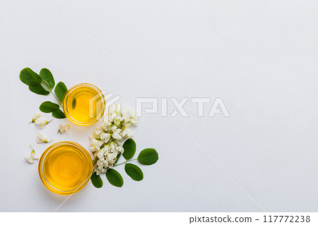 honey jar with acacia flowers and leaves. fresh honey top view flat lay honey jar with acacia flowers and leaves. fresh honey top view flat lay 117772238