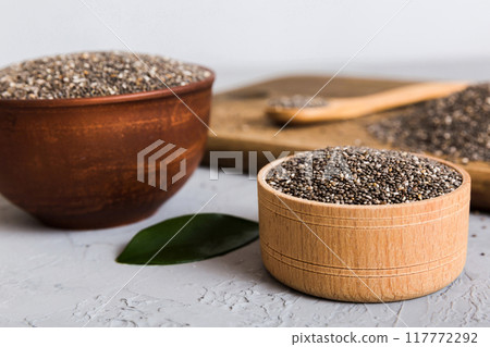 Chia seeds in bowl and spoon on colored background. Healthy Salvia hispanica in small bowl. Healthy superfood 117772292