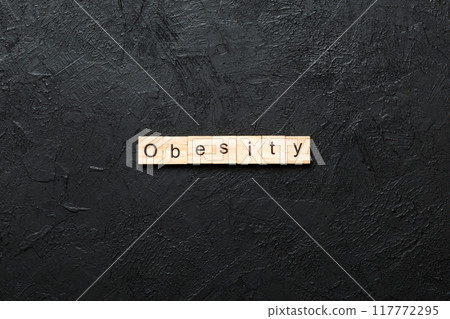 Obesity word written on wood block. Obesity text on cement table for your desing, concept Obesity word written on wood block. Obesity text on cement table for your desing, concept 117772295