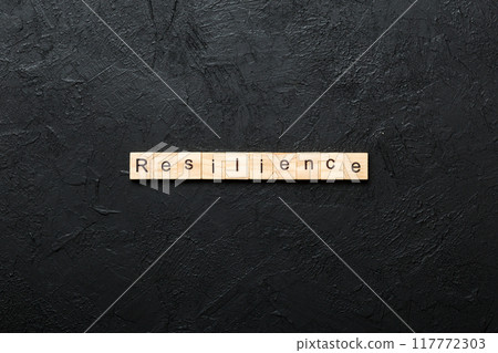 resilience word written on wood block. resilience text on table, concept 117772303