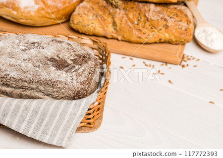Homemade natural breads. Different kinds of fresh bread as background, perspective view with copy space 117772393