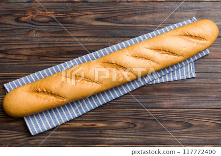 fresh crunchy french baguette on colored table. Top view Bakery products fresh crunchy french baguette on colored table. Top view Bakery products 117772400