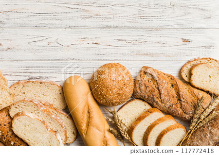 Homemade natural breads. Different kinds of fresh bread as background, top view with copy space Homemade natural breads. Different kinds of fresh bread as background, top view with copy space 117772418
