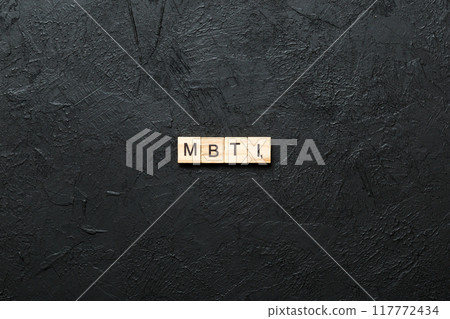 MBTI word written on wood block. Myers-Briggs Type Indicator text on table, concept MBTI word written on wood block. Myers-Briggs Type Indicator text on table, concept 117772434