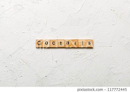 cocktails word written on wood block. cocktails text on cement table for your desing, concept cocktails word written on wood block. cocktails text on cement table for your desing, concept 117772445