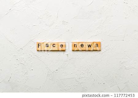 fake news word written on wood block. fake news text on table, concept 117772453