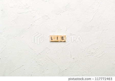 LIE word written on wood block. LIE text on cement table for your desing, concept 117772463