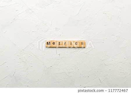 METRICS word written on wood block. METRICS text on cement table for your desing, concept 117772467