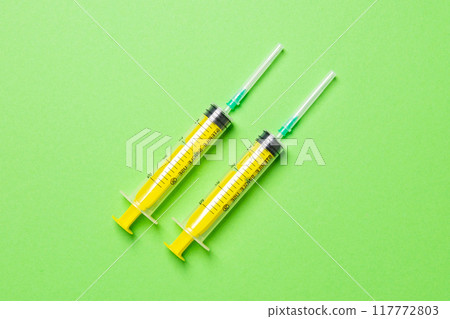 Top view of different syringes for injection on colorful background. Medical equipment concept with copy space 117772803