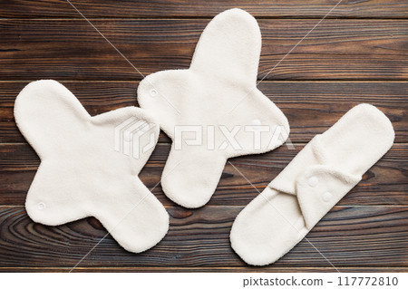 Eco-friendly reusable fabric women's pads. set of colorful bright reusable menstrual pads. zero waste woman periods concept top view with copy space Eco-friendly reusable fabric women's pads. set of colorful bright reusable menstrual pads. zero waste woman periods concept top view with copy space 117772810