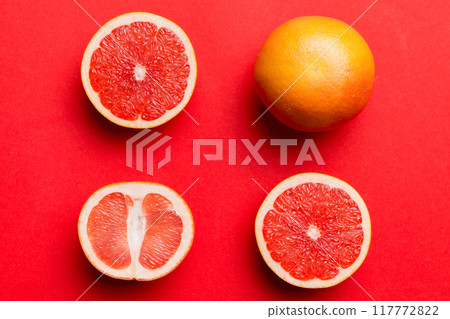 fresh Fruit grapefruit with Juicy grapefruit slices on colored background. Top view. Copy Space. creative summer concept. Half of citrus in minimal flat lay with copy space 117772822