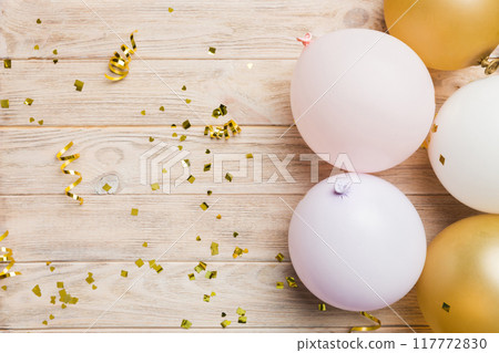 Background with fastive air balloons of round shape and confetti, multicoloured top view. Birthday party background 117772830