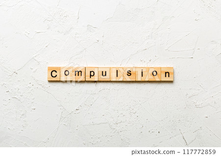 compulsion word written on wood block. compulsion text on table, concept compulsion word written on wood block. compulsion text on table, concept 117772859