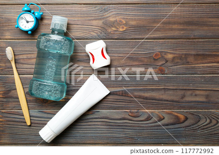 Mouthwash and other oral hygiene products on colored table top view with copy space. Flat lay. Dental hygiene. Oral care products and space for text on light background. concept Mouthwash and other oral hygiene products on colored table top view with copy space. Flat lay. Dental hygiene. Oral care products and space for text on light background. concept 117772992