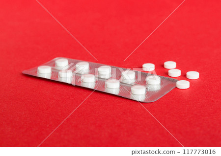 Blister package with aspirin on color background. Medicine pills on a light background. Medicines and prescription pills flat lay background. white medical tablets in blister Blister package with aspirin on color background. Medicine pills on a light background. Medicines and prescription pills flat lay background. white medical tablets in blister 117773016
