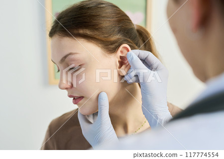 Medical Professional Examining Patient's Ear in Clinic Medical Professional Examining Patient's Ear in Clinic 117774554